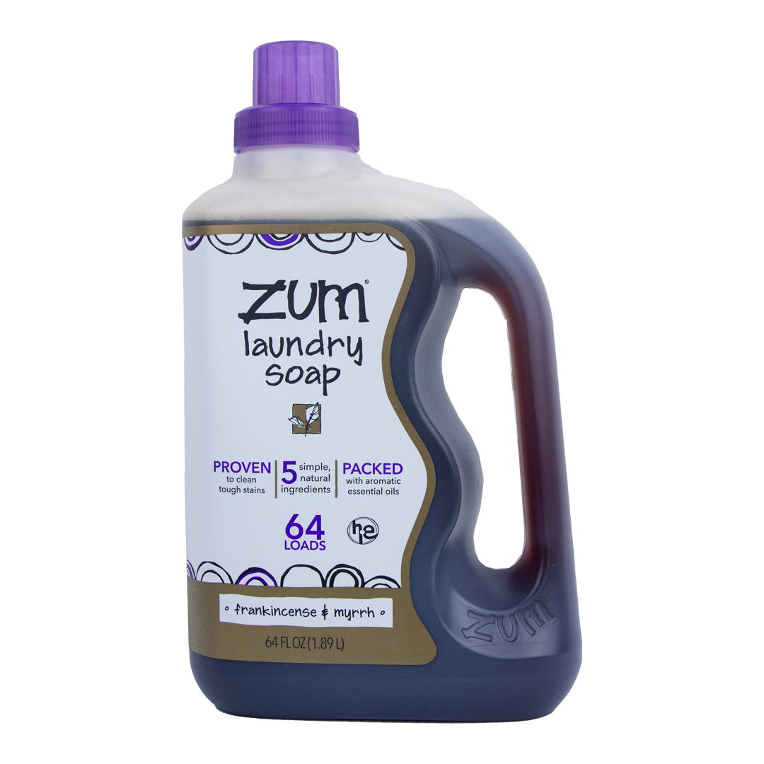 A bottle of Zum brand laundry soap in a purple liquid soap container, with a label indicating Frankincense & Myrrh scent and 64 oz volume.